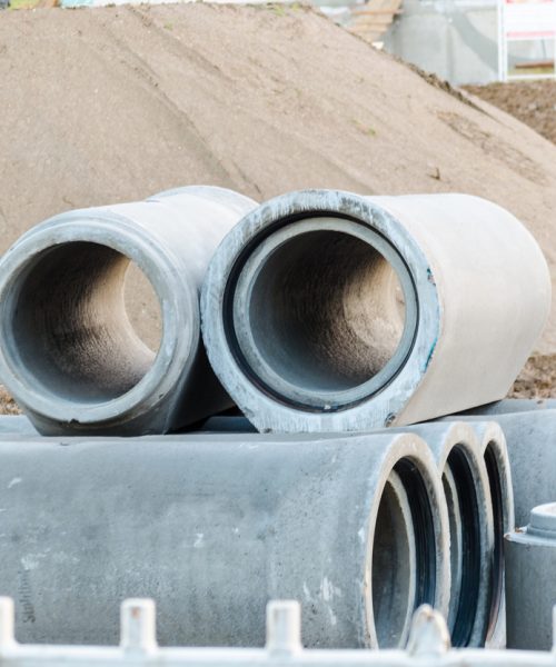 Wastewater, sewage pipes made of concrete at a construction site.